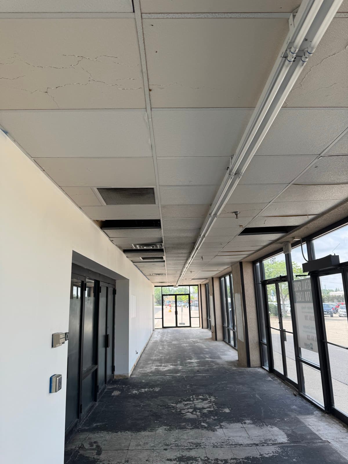 Vacant retail storefront corridor before turnover cleaning